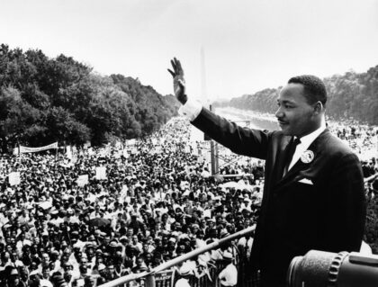 Black & white photo of MLK at large rally.